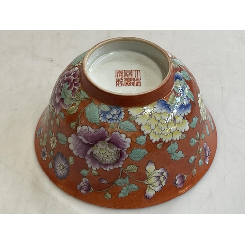 173 - Chinese bowl with floral and famille rose design on orange ground, iron red stamp to base, 13cm.