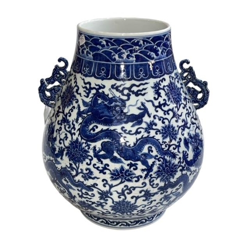 179 - Large Chinese blue and white two handled bulbous vase decorated with dragons and flowers, Qianlong m... 