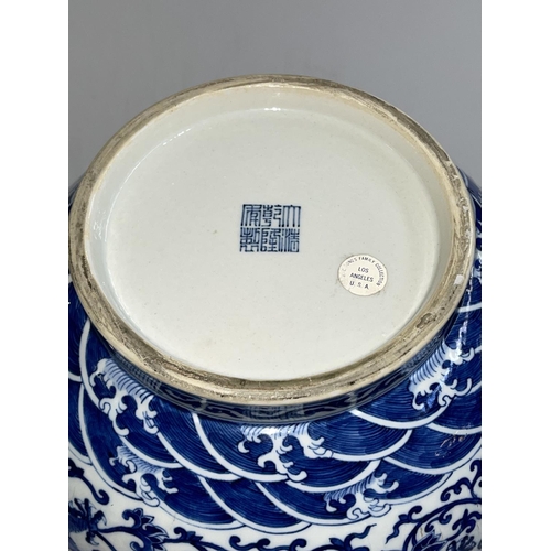 179 - Large Chinese blue and white two handled bulbous vase decorated with dragons and flowers, Qianlong m... 