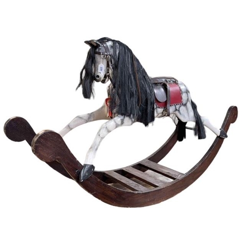 405 - Sponge painted rocking horse with leather saddle, 102cm by 176cm.