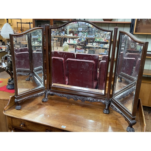 409 - Edwardian mahogany triple bevelled dressing mirror on paw feet.