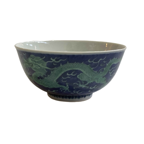 167 - Chinese bowl decorated with green painted dragon on blue ground, blue Qianlong mark to base, 15cm.