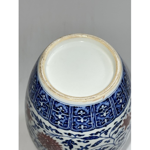 151 - Large Chinese blue and white vase with red floral pattern, 39cm.