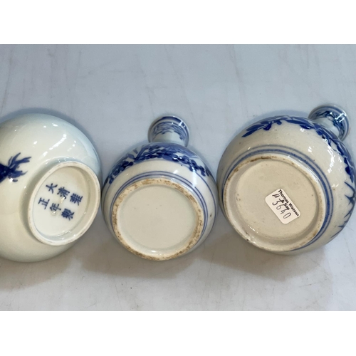 162 - Three Chinese blue and white bottle neck vases.