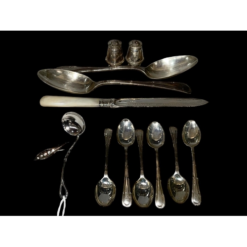 243 - Pair silver tablespoons, six silver teaspoons, small silver ladle, cake knife, cruet and brooch.