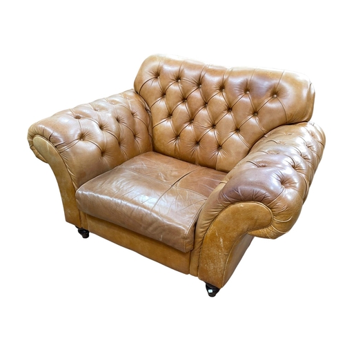 375 - Large tan deep buttoned leather club armchair.