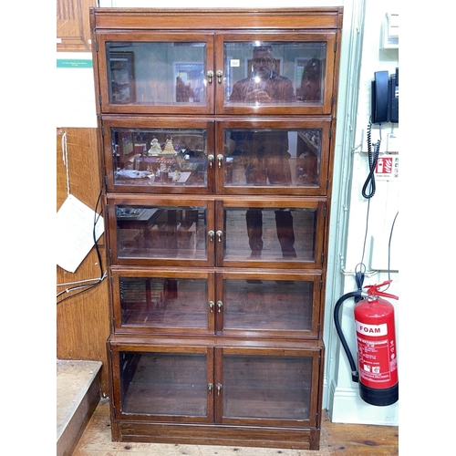 382 - Early 20th Century mahogany five height bookcase with ten bevelled glass doors, 174.5cm by 89cm by 2... 