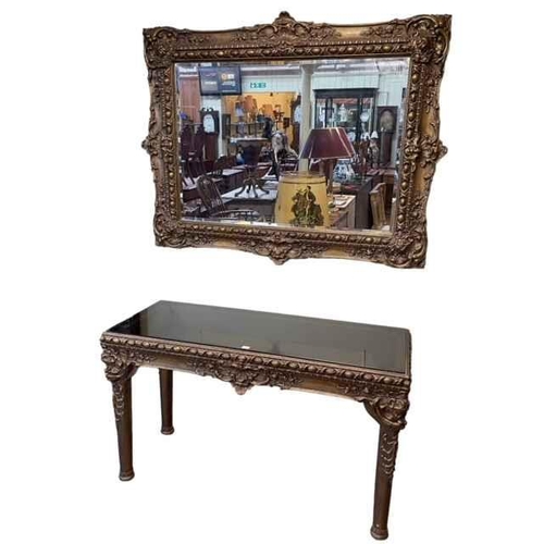 416 - Gilt and tinted glass console table and bevelled wall mirror, table 78cm by 134cm by 53cm, mirror 11... 