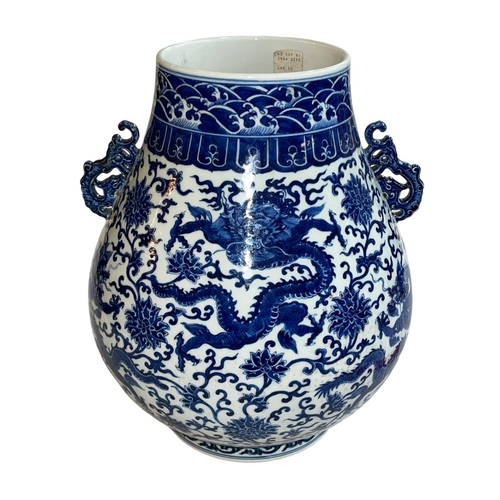 139 - Large Chinese blue and white two handled bulbous vase decorated with dragons and flowers, Qianlong m... 