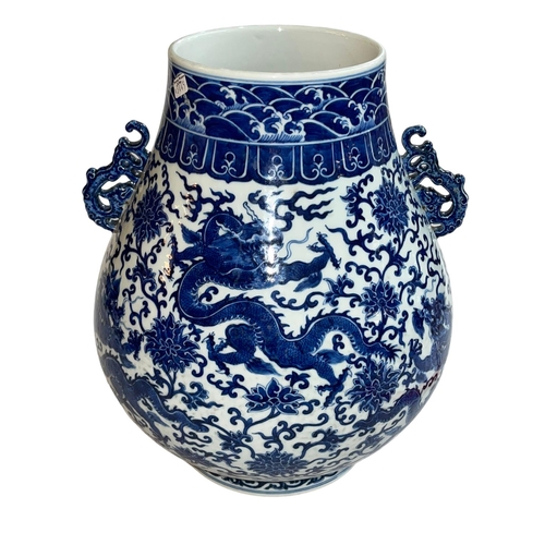 139 - Large Chinese blue and white two handled bulbous vase decorated with dragons and flowers, Qianlong m... 