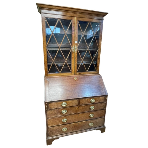 361 - Georgian oak bureau bookcase having pair of astragal glazed doors above a fall front with five drawe... 