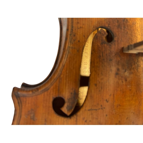 110 - Cased violin bearing label 'Wolff Bros no 287, dated 1888'.