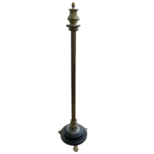 374 - Brass reeded column standard lamp on three paw feet.