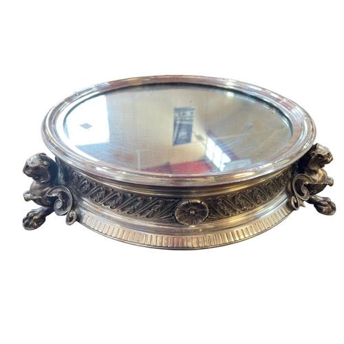 117 - Impressive silver plated and mirror topped cakestand raised on lion mask and paw feet.