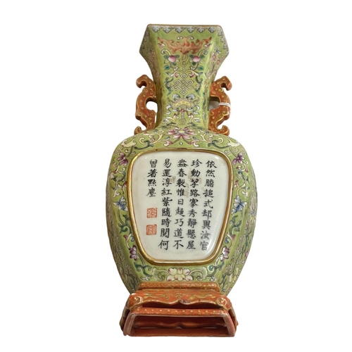 147 - Chinese pottery wall vase decorated with floral design and verse, 21cm high.