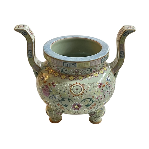 153 - Chinese lime green ground famille rose two handled incense burner raised on three bulbous legs, 27cm... 