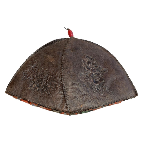 159 - 19th Century Chinese leather hat with embossed decoration and red central band.