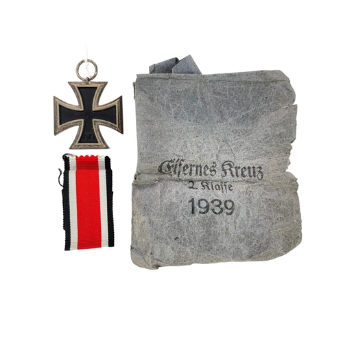 179 - A German WWII Iron Cross with ribbon in original paper bag.