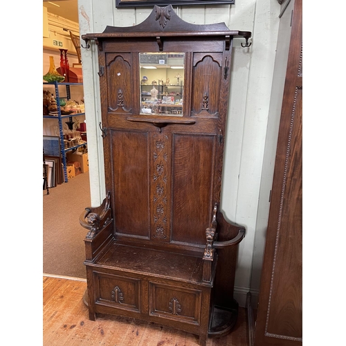 378 - 1920's carved oak hallstand with box seat, 165cm by 120cm by 37cm. (Evidence of Woodworm).