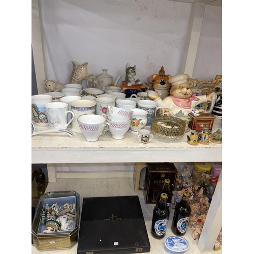 87 - Two full shelves of china, novelty teapots, collectors plates, Piggin Pigs, tableware, Hine Brandy, ... 