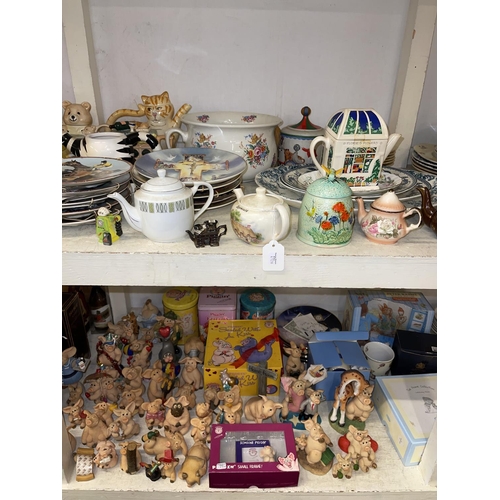 87 - Two full shelves of china, novelty teapots, collectors plates, Piggin Pigs, tableware, Hine Brandy, ... 