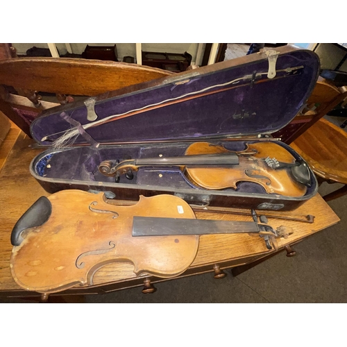 89 - Two vintage violins, three bows and one case.