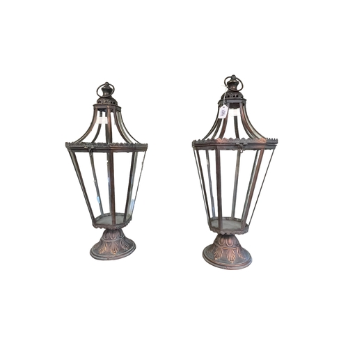 127 - Pair of ornate metal and glazed hall hanging lanterns.
