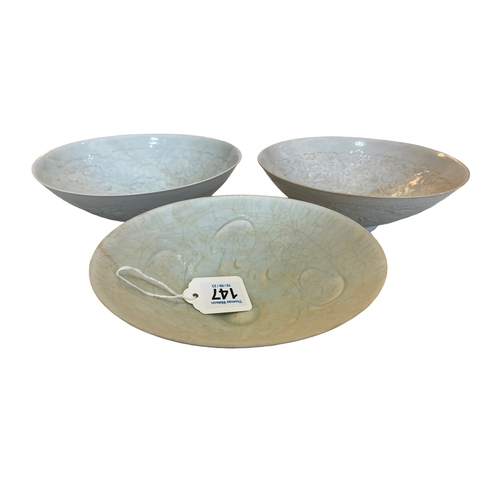 147 - Three Celadon bowls, largest 20cm diameter.