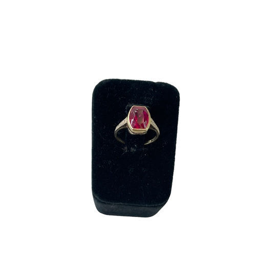 169 - Gold and red stone ring, size J.