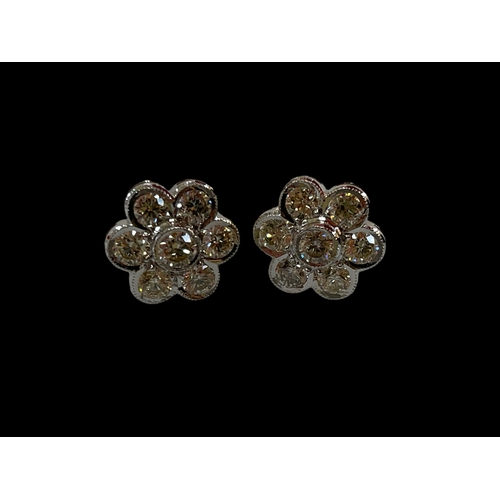 187 - Very impressive diamond cluster 18k white gold earrings, each set with seven diamonds, total approxi... 