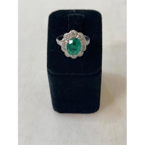 188 - Impressive emerald and diamond cluster ring having oval approximately 2 carat emerald bordered with ... 