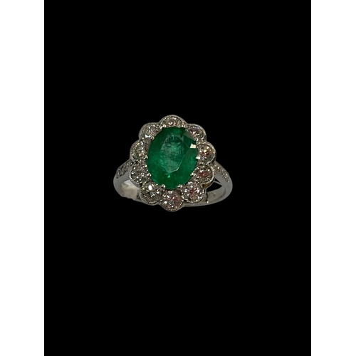 188 - Impressive emerald and diamond cluster ring having oval approximately 2 carat emerald bordered with ... 