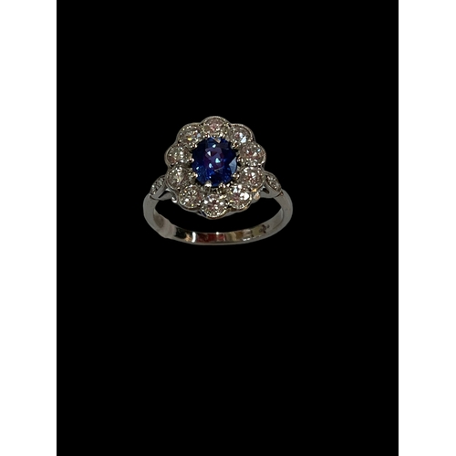 191 - Stunning sapphire and diamond cluster 18 carat white gold ring, the cushion sapphire bordered with t... 