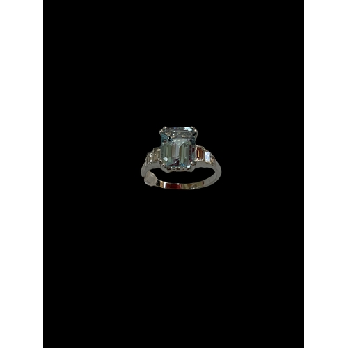 199 - Aquamarine and diamond white gold ring, having 1.5 carat aqua with baguette set shoulders, size O.