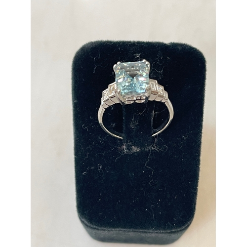 199 - Aquamarine and diamond white gold ring, having 1.5 carat aqua with baguette set shoulders, size O.