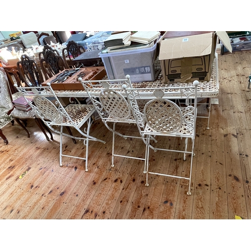 364 - Metal lattice work design garden table and six folding chairs, table 153cm by 76cm.