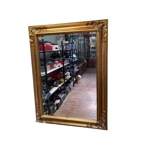 370 - Rectangular gilt framed bevelled wall mirror, 119.5cm by 89.5cm.