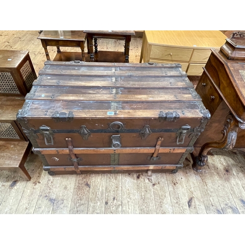 393 - Vintage wood and metal bound travelling trunk, 65cm by 98cm by 58cm.