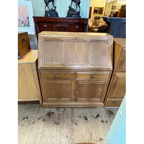 402 - Ercol Golden Dawn bureau, the fall front above two drawers and two cupboard doors, 108cm by 93.5cm b... 