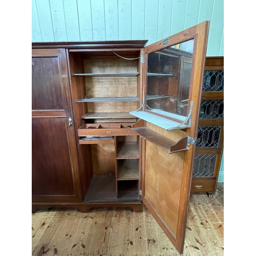 411 - Early 20th Century mahogany two door compactum wardrobe, 177cm by 137.5cm by 55cm.