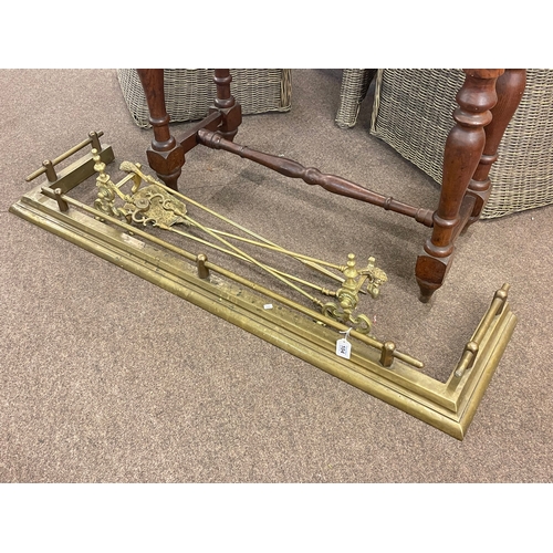 104 - Victorian brass kerb, three fire irons and pair of dogs.