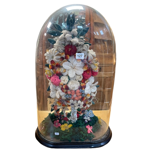 127 - Victorian woollen floral display under glass dome, 66cm high.