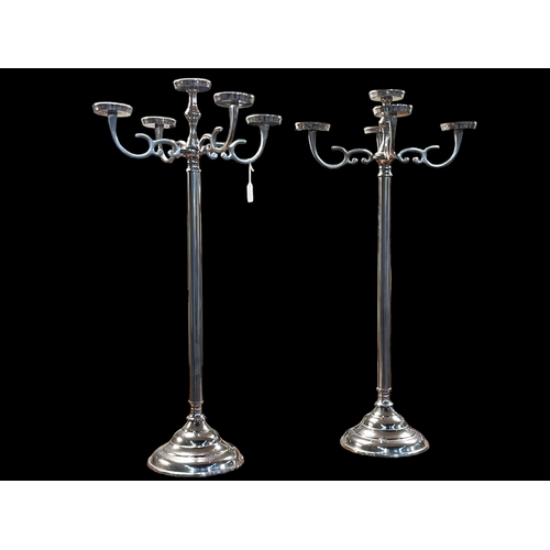 128 - Pair of white metal five branch candelabra, 89cm high.