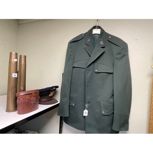 64 - Two Military jackets, four belts, two caps, two shell cases and cased binoculars.