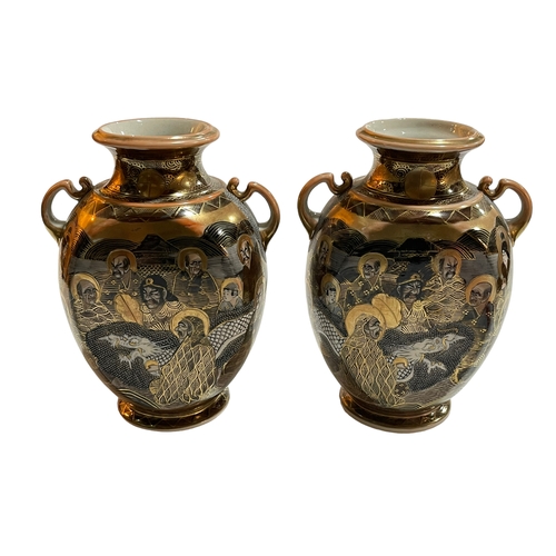 159 - Pair of Japanese Satsuma two handled vases decorated with dragon and figures, 24cm.