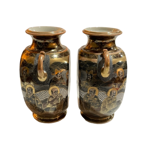 159 - Pair of Japanese Satsuma two handled vases decorated with dragon and figures, 24cm.