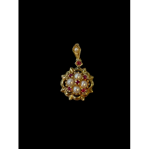 181 - Pearl and ruby pendant set in 18 carat yellow gold.