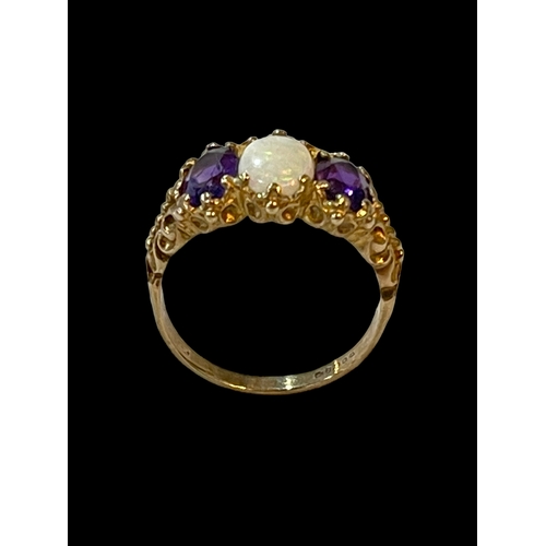 194 - Opal and amethyst three stone 9 carat gold ring, size Q.