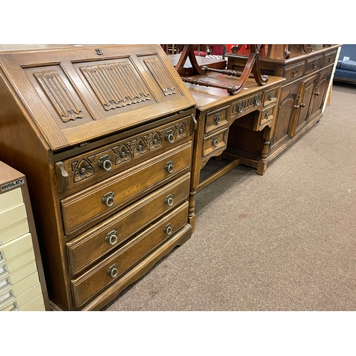 322 - Oak linen fold panel four drawer bureau, similar five drawer side table and three door dresser (3).