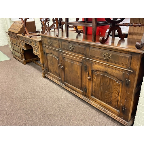 322 - Oak linen fold panel four drawer bureau, similar five drawer side table and three door dresser (3).